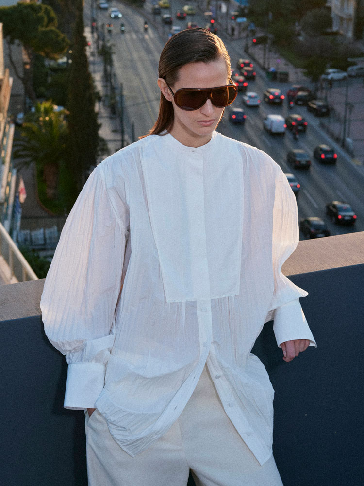 man wearing turtleneck standing on balcony